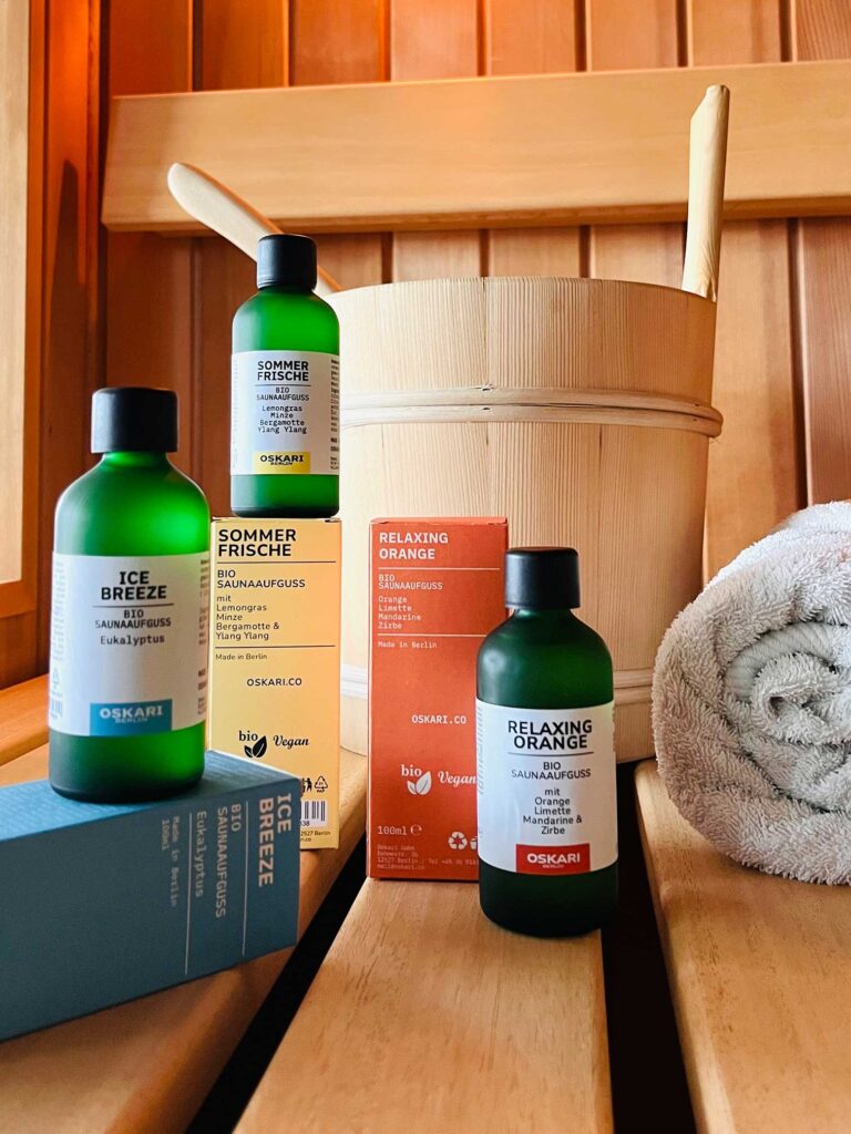 Oskari Berlin Saunaaufgüsse in der Sauna der Ferienwohnung FISCHER:IN auf Rügen mit Handtuch und Holzeimer